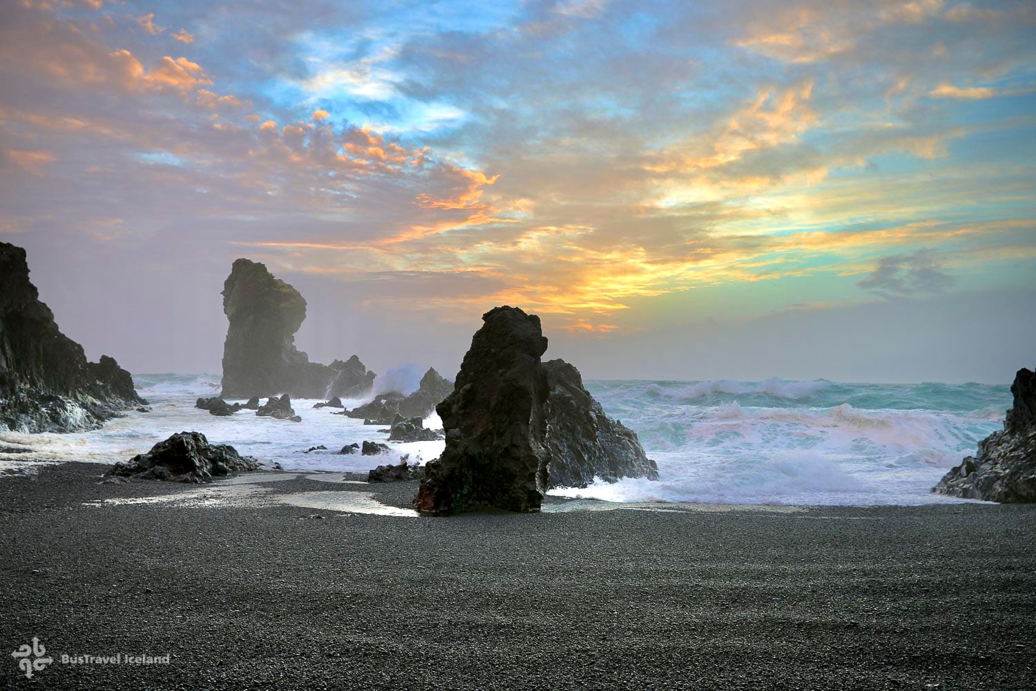 Sunset on black pebble beach in Iceland