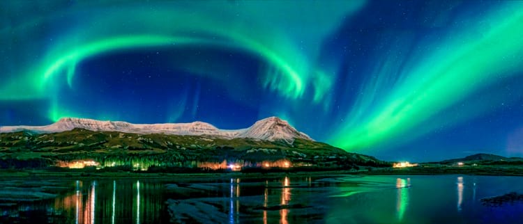 northern-lights-over-snow-capped mountains